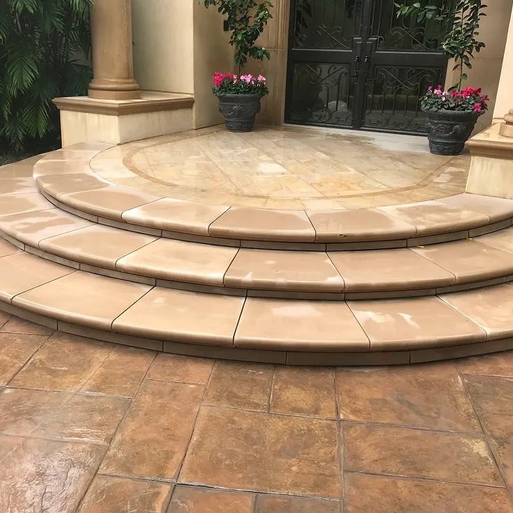 Curved tiled entry steps with decorative flooring.