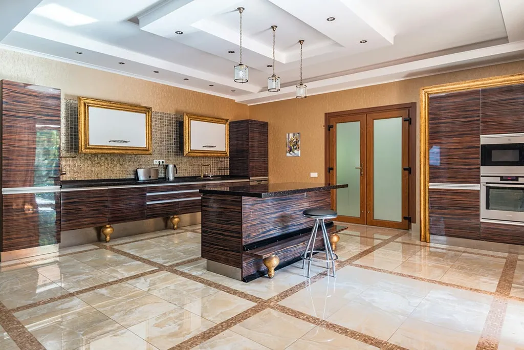 Elegant luxury kitchen with golden accents, glossy cabinets, and modern island design